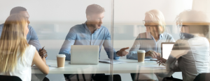 Representatives collaborating in a conference room, illustrating the partnership between Optima Juris and ABC Legal to launch Process Service+
