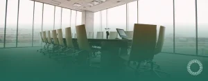 Empty modern conference room with a long table, rows of chairs, and floor-to-ceiling windows, Optima Juris logo bottom right.